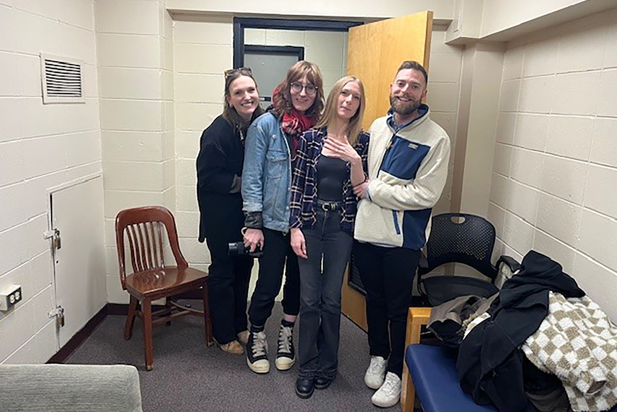 Photo: Four people pose for a photo as the man, on the furthest right, just proposed to his girlfriend, middle right, in the common room they met in.