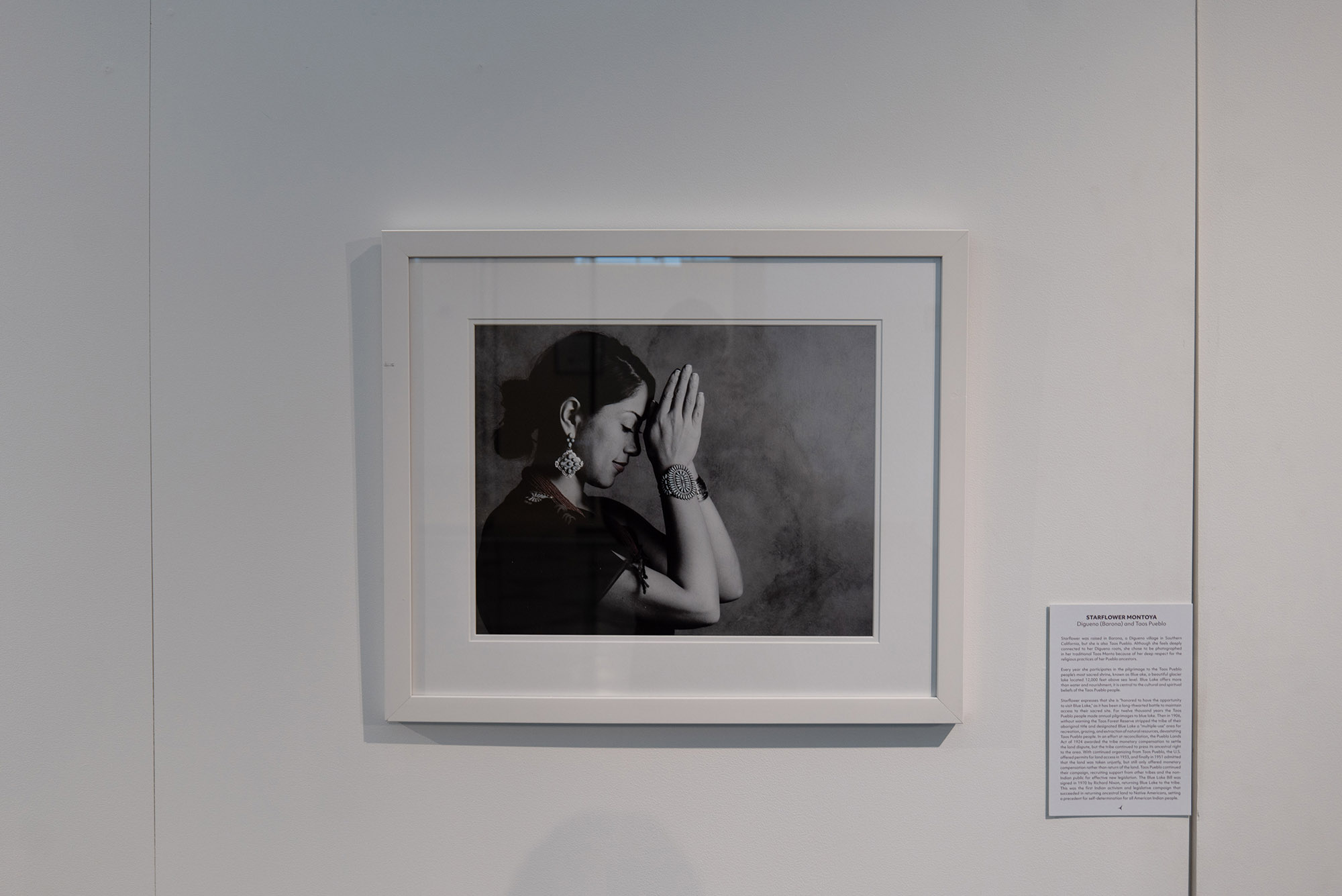 Photo: A photographer of a framed photo of Starflower Montoya of the Digueno and Taos Pueblo indigenous tribe is pictured in a traditional Taos manta dress as she makes a yearly pilgrimage to Blue Lake, a key tradition of her tribe. The photo, taken by Matika Wilbur, is part of an exhibition at the 808 Gallery called Natural Wanderment: Stewardship.