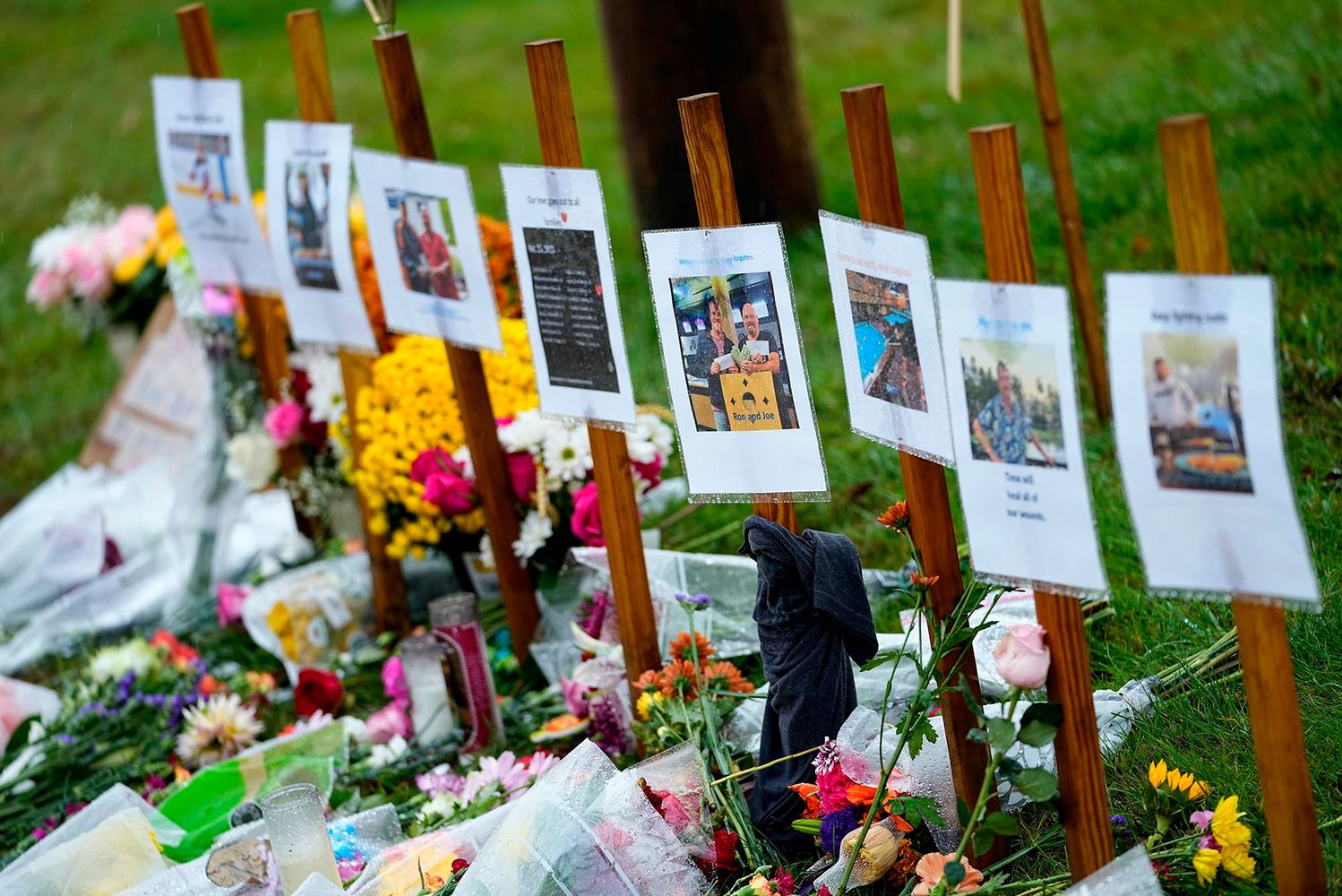 Photo: ain soaked memorials for those who died in a mass shooting sit along the roadside by Schemengees Bar.