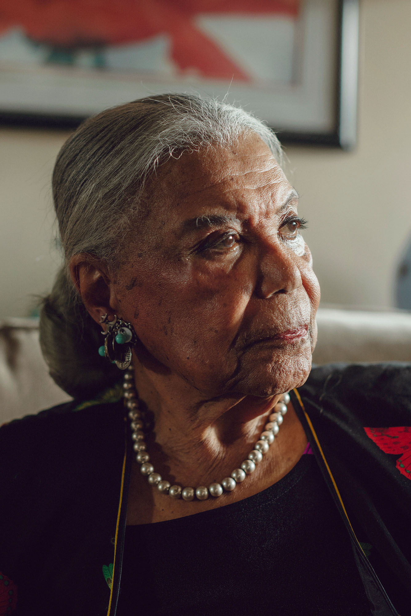 Photo: A portrait shot of Virginia Allen, an older Black woman with her gray hair pulled back into a bun. She wears a Black top and pearls.