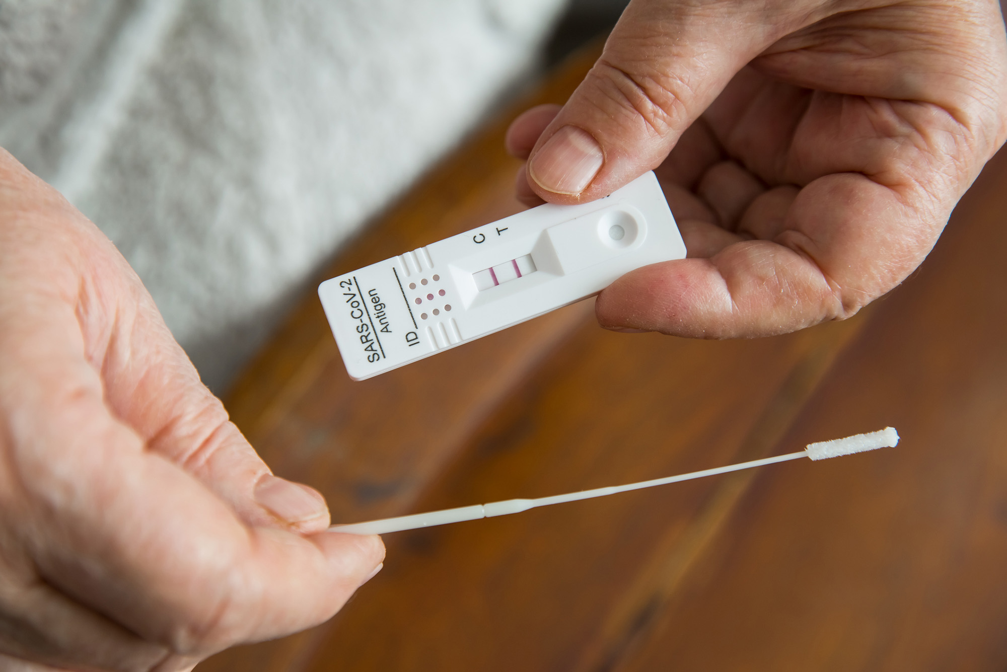 Photo: A stock image of a individual taking a COVID test.