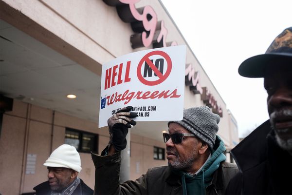 Photo: A group of men protesting outside of a Walgreens. The one in the middle is holding a sign that says "Hell No Walgreens" with a circle and a line over the "No"