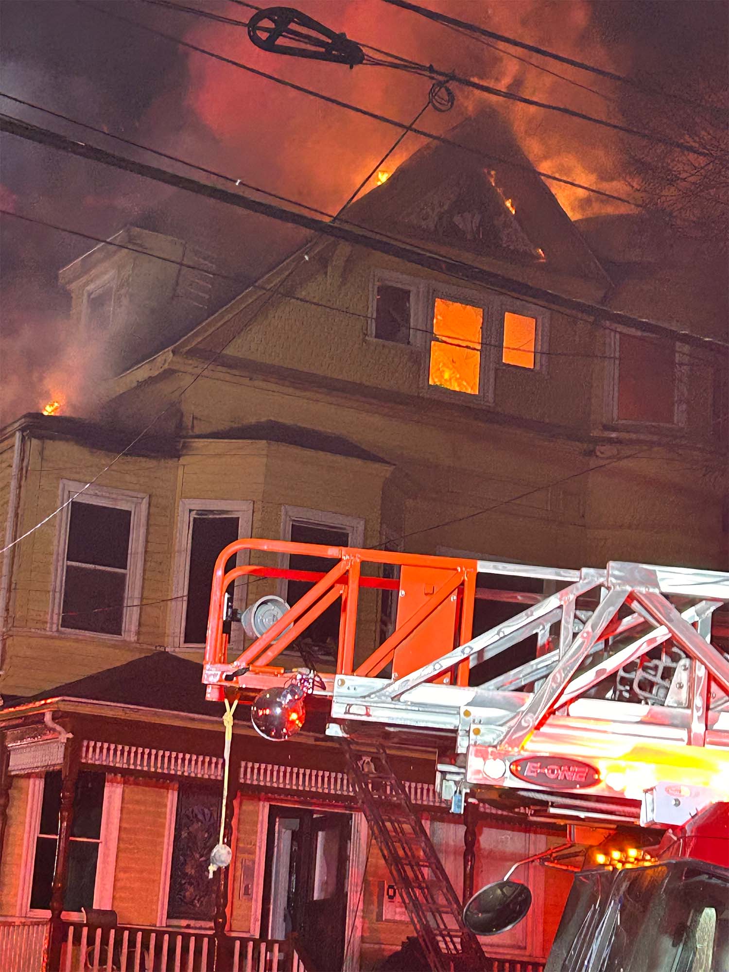 Photo: A house fire in Boston in March 2024, a house is visibly burning and there is a fire truck in front of the house