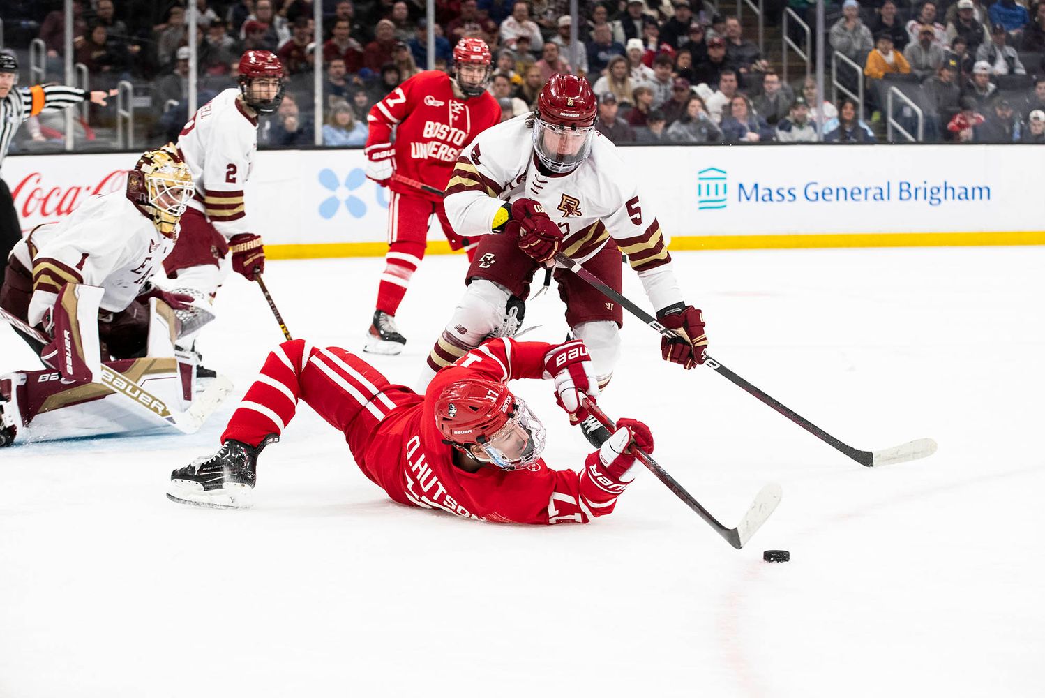 Photo: BU forward Quinn Hutson’s (CAS’26) fishes for a puck off his back in the 2024 Hockey East Championship.