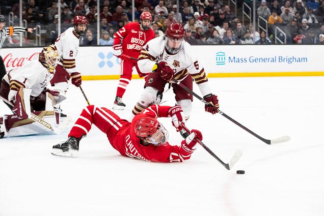 Photo: BU forward Quinn Hutson’s (CAS’26) fishes for a puck off his back in the 2024 Hockey East Championship.