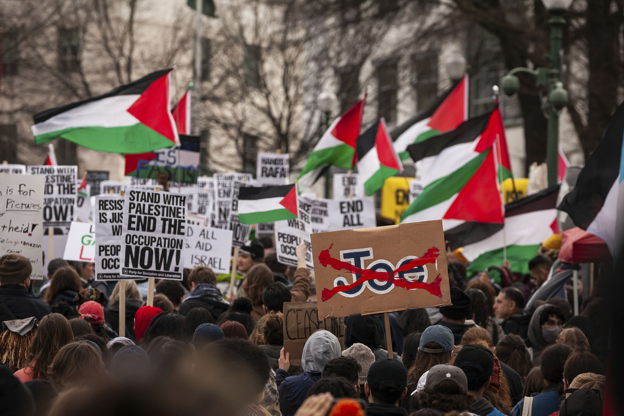 Photo: A demonstrator raises an anti-Biden sign as thousands of people protest outside the Israeli Embassy against the planned ground invasion of Rafah, Gaza