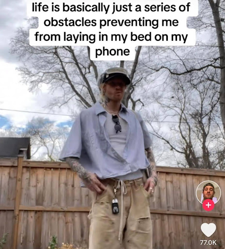 A screenshot from a tiktok with a guy that has his hands in his pockets and the text overlay reads "life is basically just a series of obstacles preventing me laying in my bed on my phone"