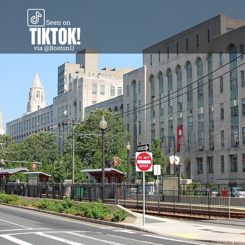 Photo: Boston University's campus on a sunny day, with an MBTA stop in front of a large ornate stone building. Text overlay reads "seen on TikTok via @bostonu"