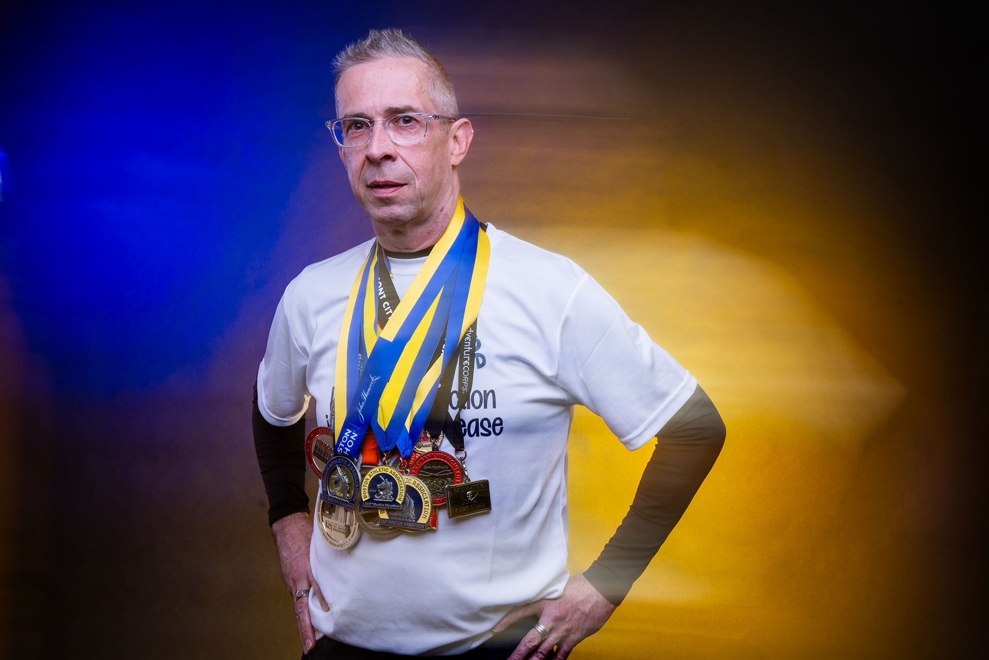 Photo: A picture of man posing with his hands on his hips. He has many medals around his neck