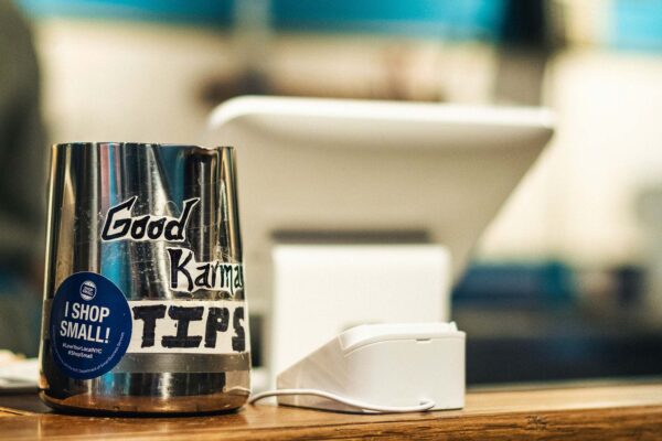 Photo: A tip jar with a sticker reading "Good Karma: Tips: