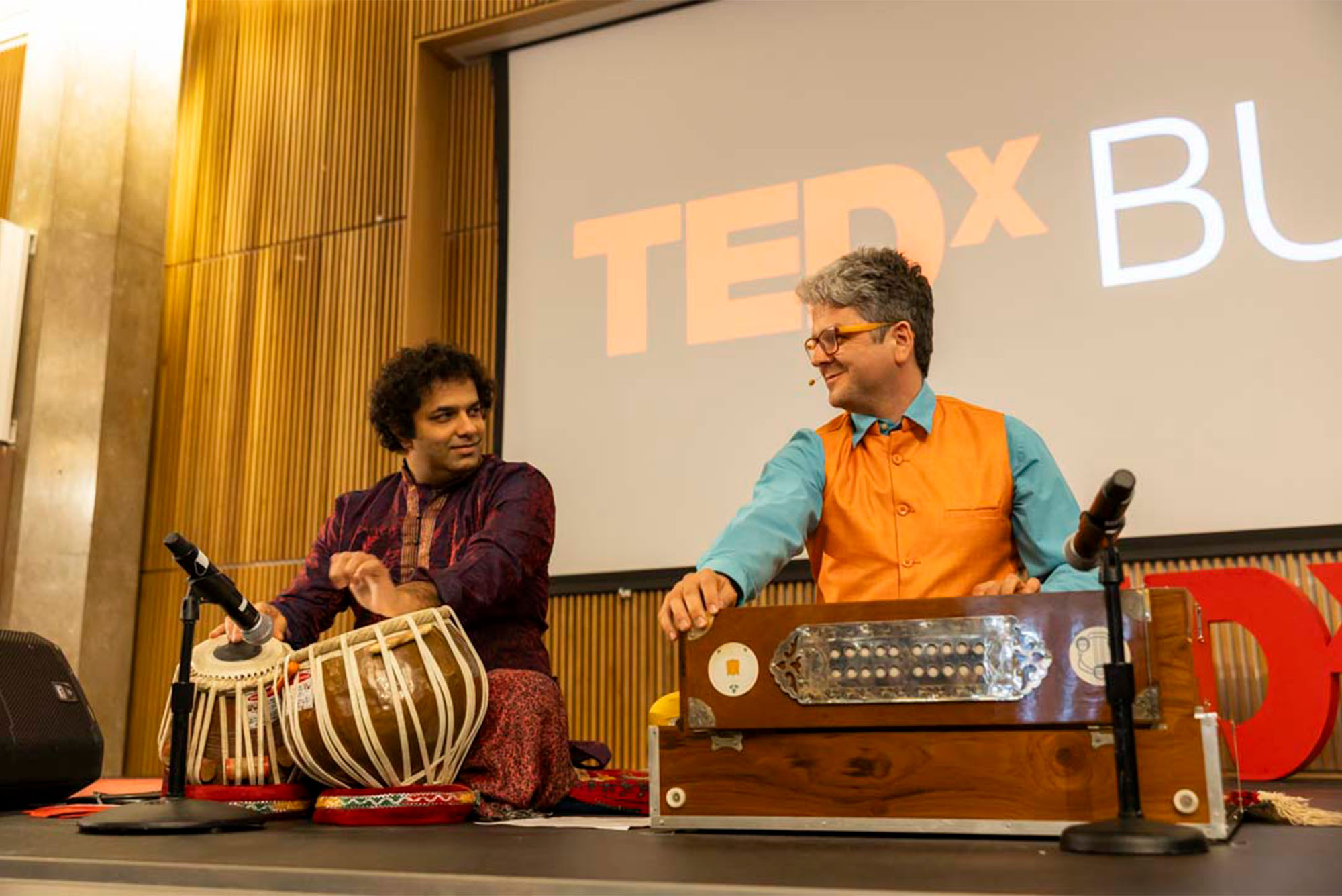 Photo: Amit Kavthekar (left), an Indian Tabla musician, and Igor Iwanek, a College of Fine Arts lecturer in performance, guided the audience in a breathwork exercise and played rhythmic music during their time on stage.