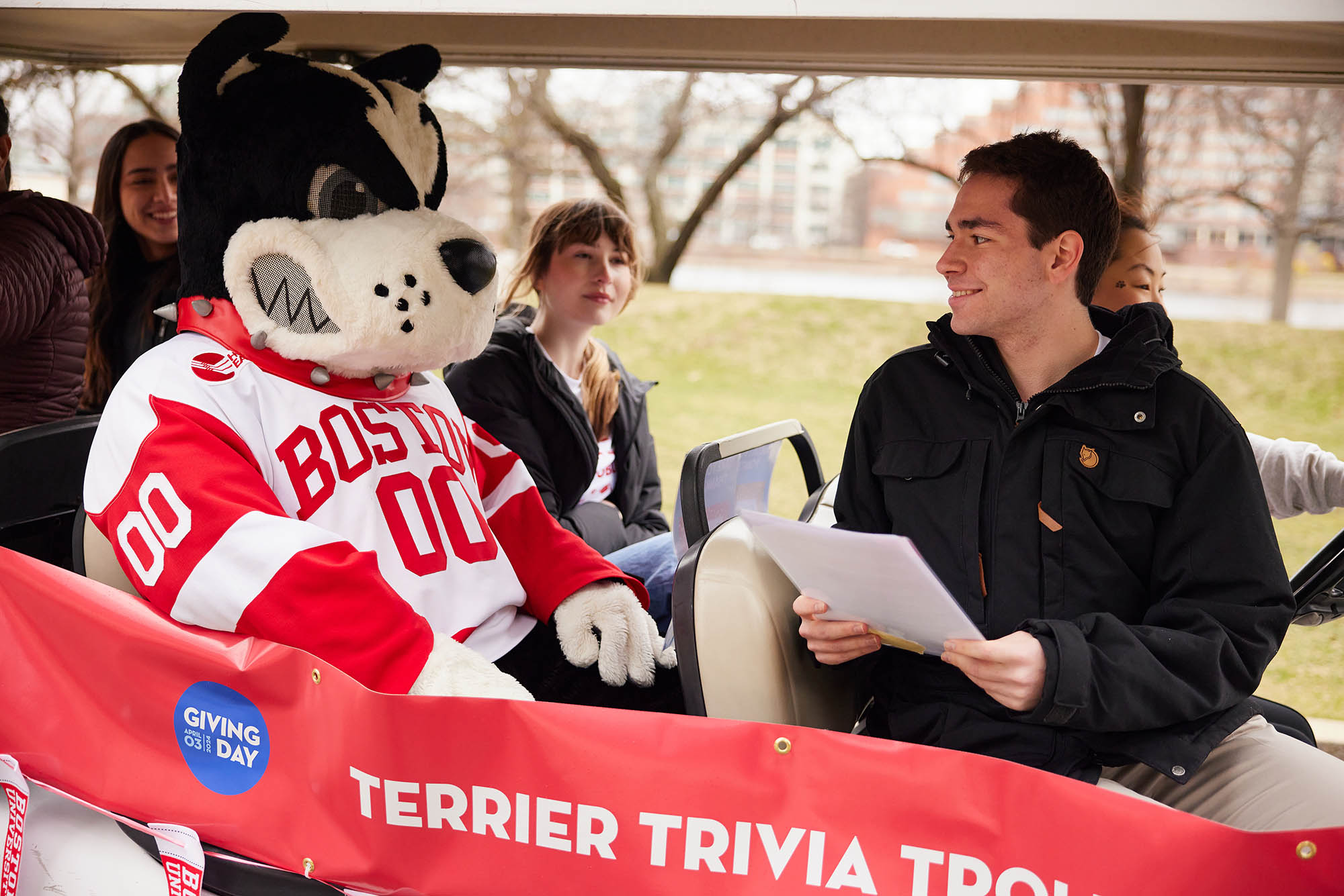 Photo: Rhett next to a few individuals on the Trolley for Giving Day