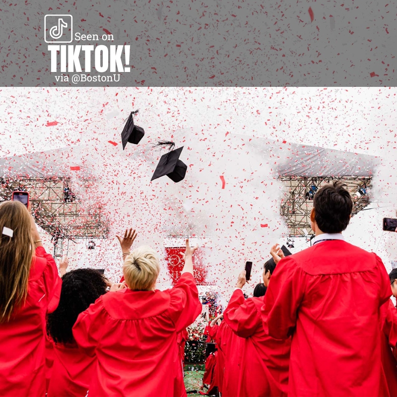 Photo: A large group of graduating seniors in red robes at Boston University's commencement toss their mortarboards into the sky. Text overlay reads "Seen on tiktok via @bostonu"