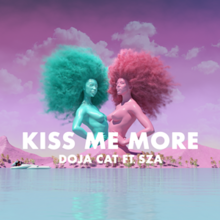 The song cover photo to "Kiss Me More" (feat. SZA) by Doja Cat. The photo is of a pink sky and mountains, with blue water. There are two statues of women, one pink and one blue, facing one another from the waist up. Their hair is poofy and flying behind them. There is text across the screen with the song title. 