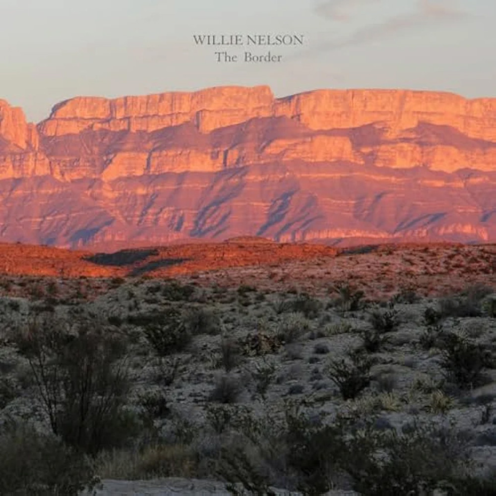 Photo: A picture of a natural landscape with the words "Willie Nelson The Border" as a text overlay