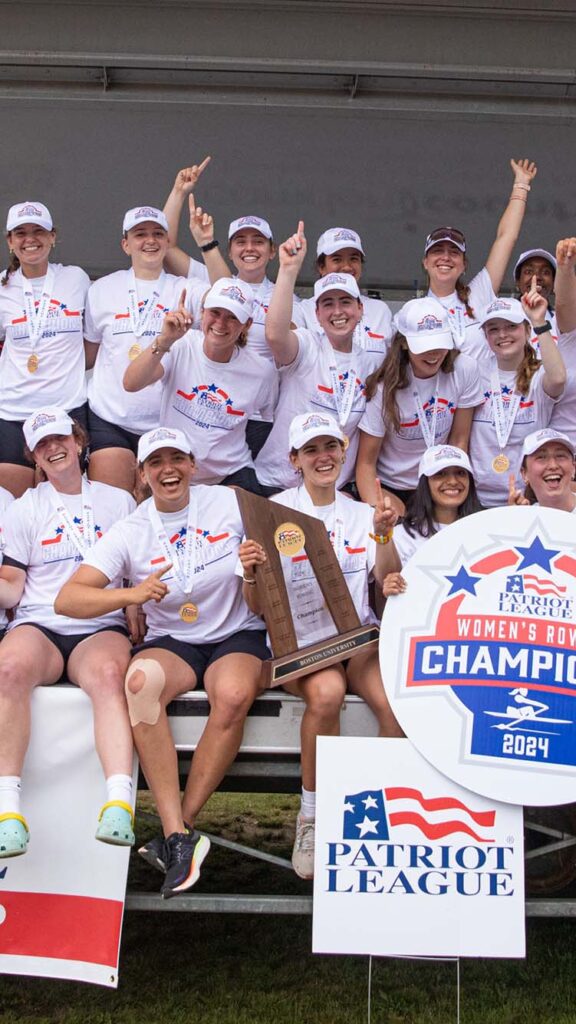Photo: A picture of the BU Women's Rowing team smiling and posing around a sign that says "Women's Rowing Champions 2024"