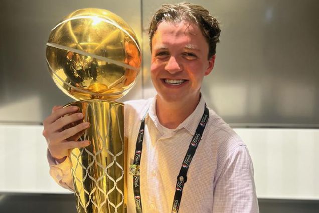 Photo: A picture of a man holding up a trophy in celebration