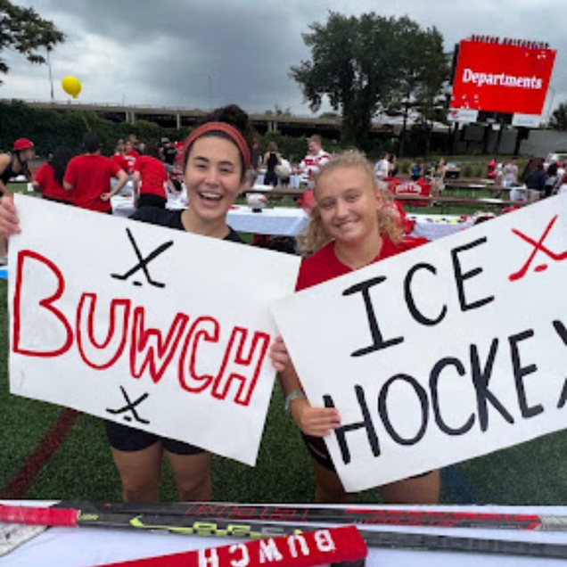 Photo: Two students holding signs that read "BUWCH" and "ICE Hockey"