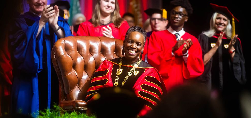 Photo: Melissa L. Gilliam sits in the leather chair that belonged to one of BU’s founders, Isaac Rich. The chair was used in 1869 when a petition was signed to charter BU as a new corporation.