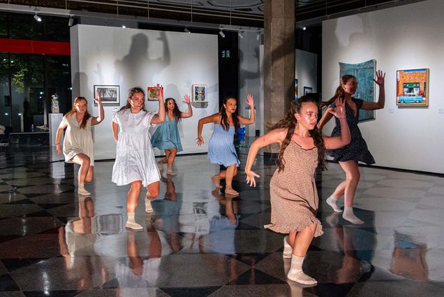 Photo: A group of students hit a coordinated dance move at a BU performance, MOTION ART.