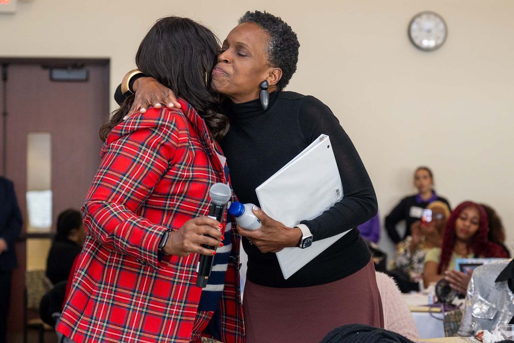 Photo: Melissa L. Gilliam hugging a guest at the Mothers Against Violence National Conference