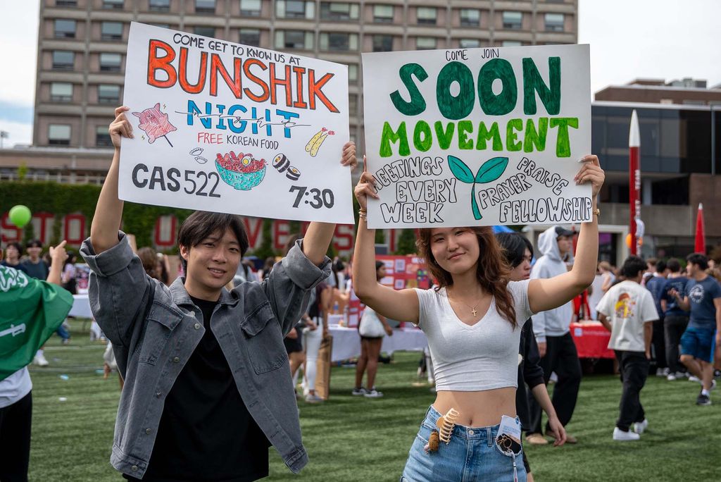 Photo: Students holding up signs at BU's SPLASH event