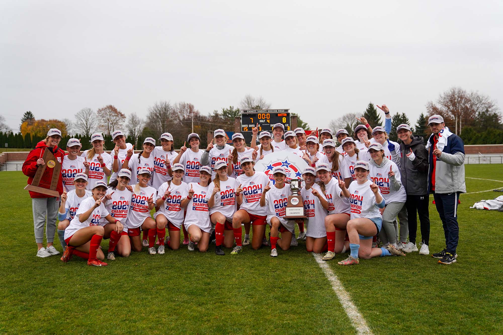 Photo: A team photo of the BU Women's soccer team holding a trophy