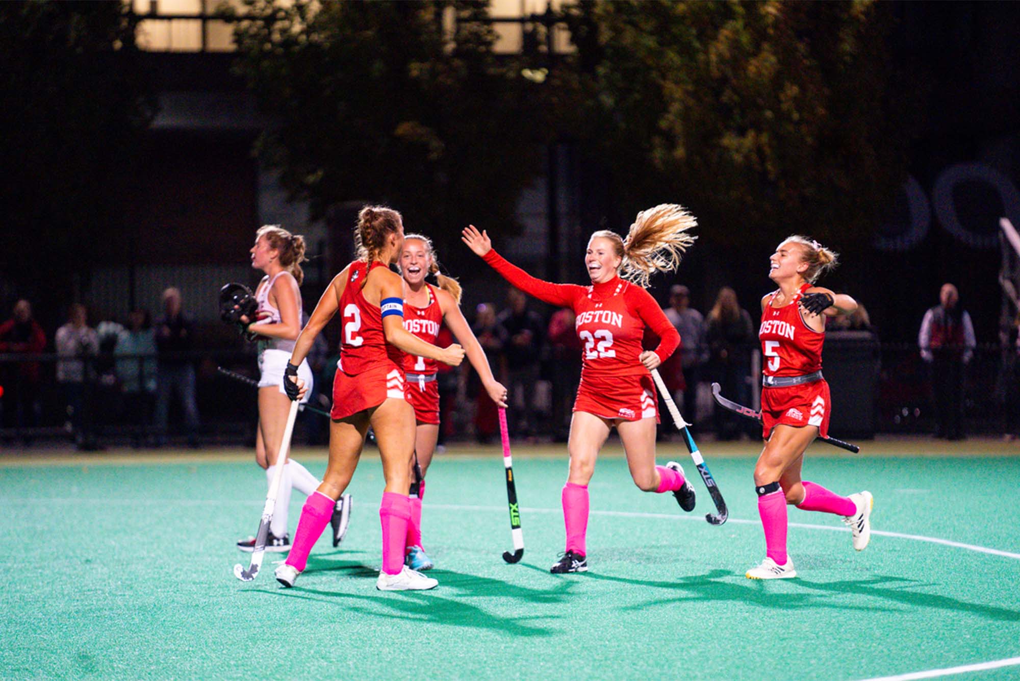 Photo: Women's field hockey players embrace each other on field during a recent match
