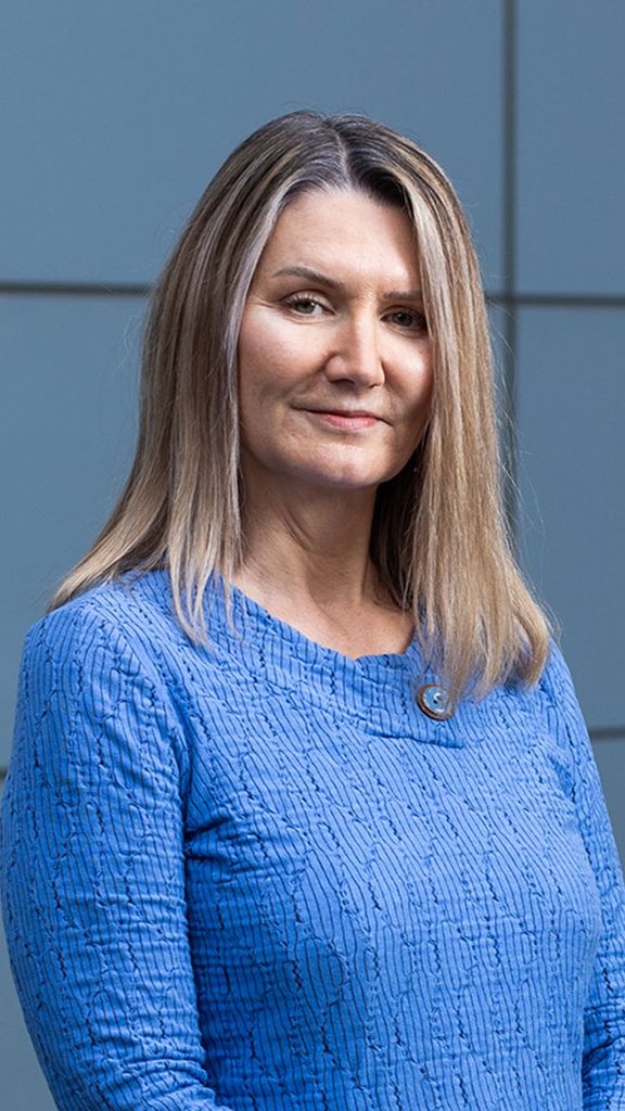 Photo: A woman in an elegant blue top