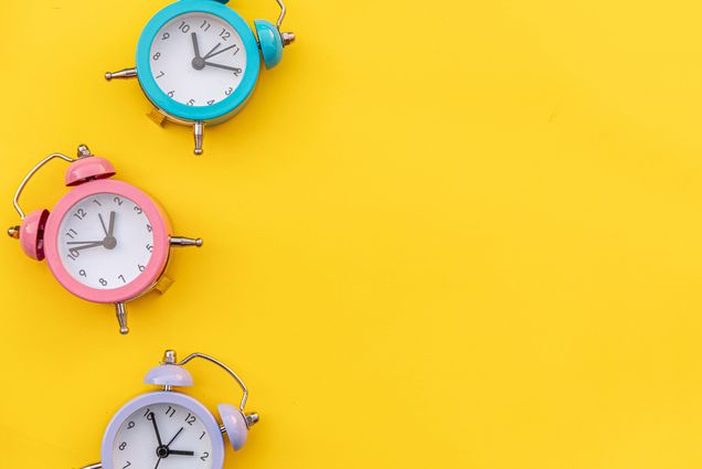 Photo: Three ringing alarm bells on a yellow background
