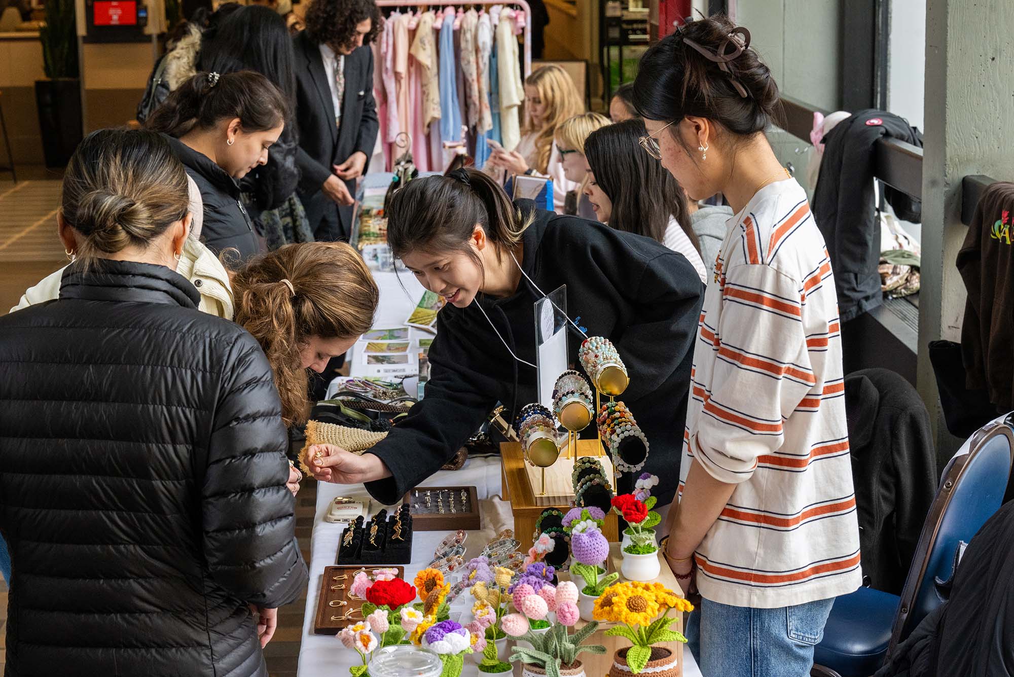 Photo: BU students at a table at the art market