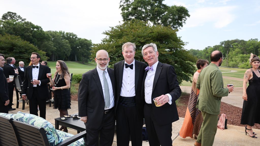 Photo: Three men in suits pose for a portrait at a formal gathering