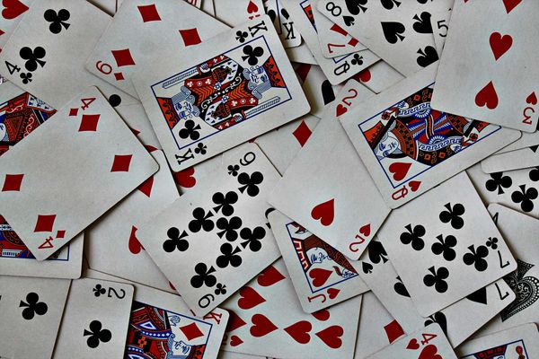 Photo: A deck of cards scattered across a table