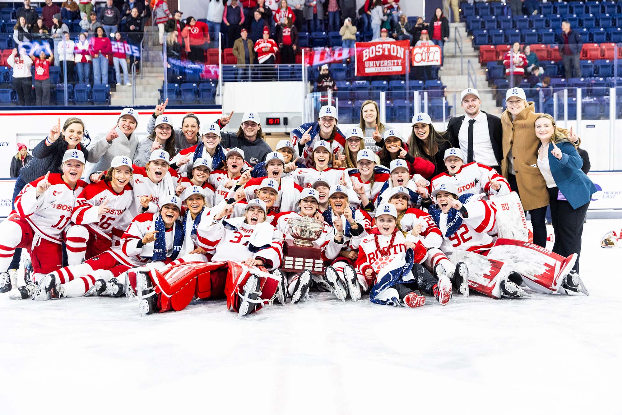 Photo: BU Women's Hockey team holding their trophy after winning the Hockey East Tournament