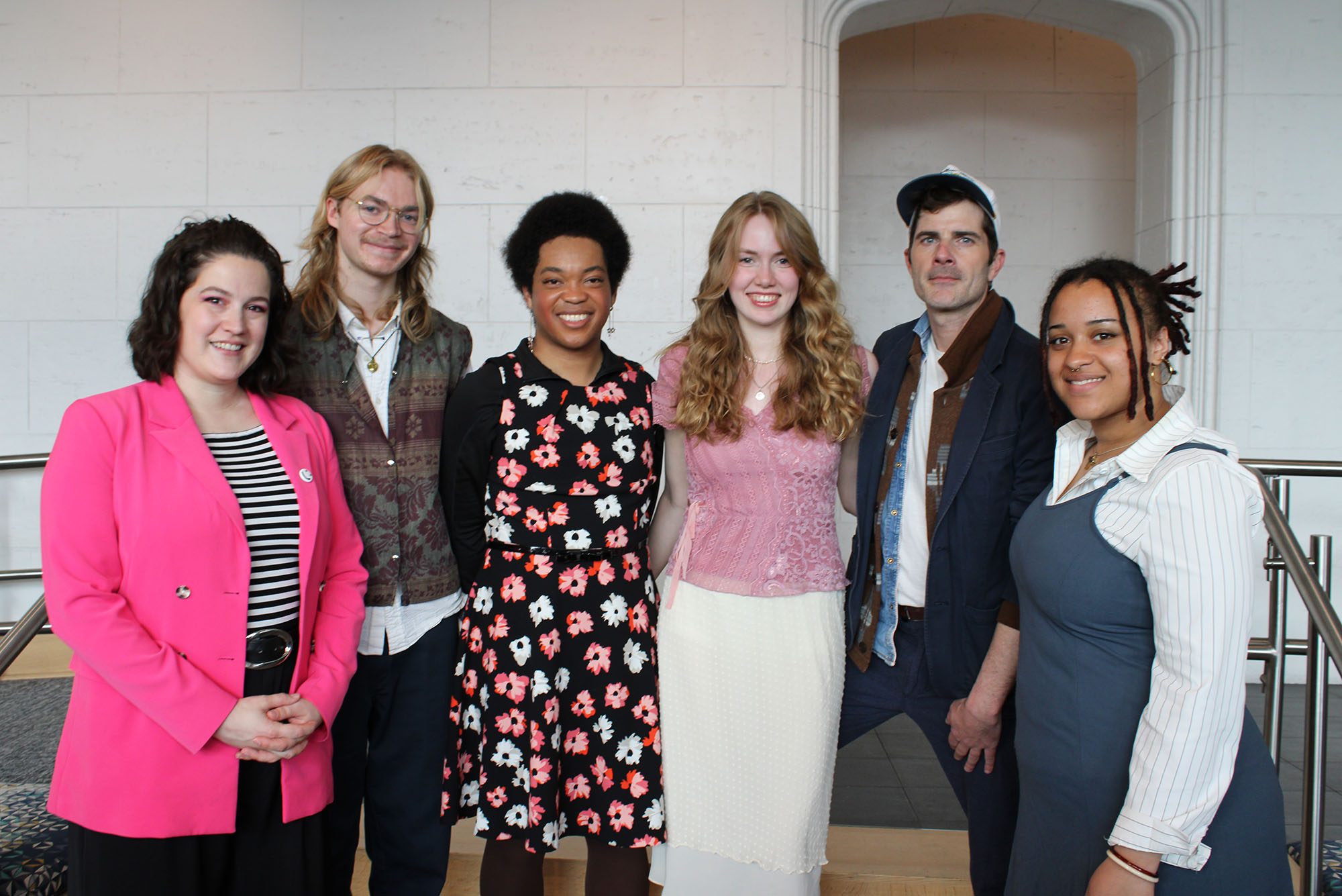 Photo: The recipients of Kahn Awards, six BU students smiling and posing in a line