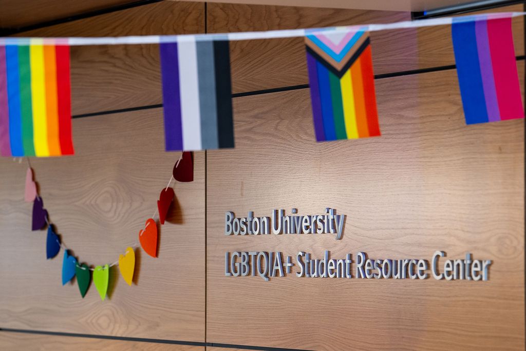 Photo: The Boston University LGBTQIA+ Student Resource Center decorated with flags, including a Progress Pride flag