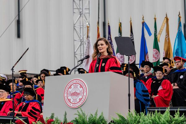 Photo: Commencement speaker Emily Deschanel in Boston University graduation regalia speaks to the Class of 2025.