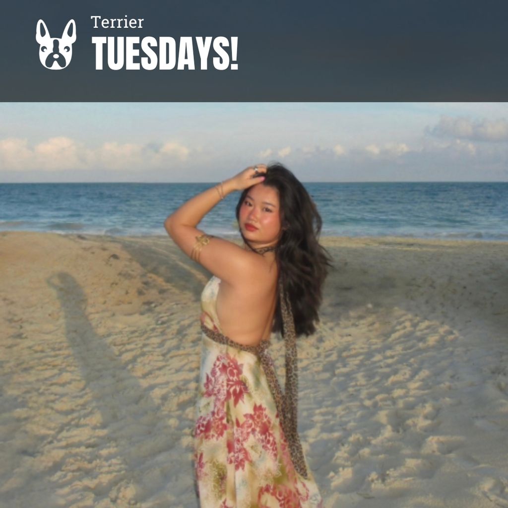 Photo: A woman on the beach poses for a photo. Text overlay reads "Terrier Tuesdays!"