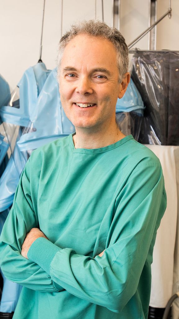 Photo: Robert Davey poses for a portrait in his BU lab