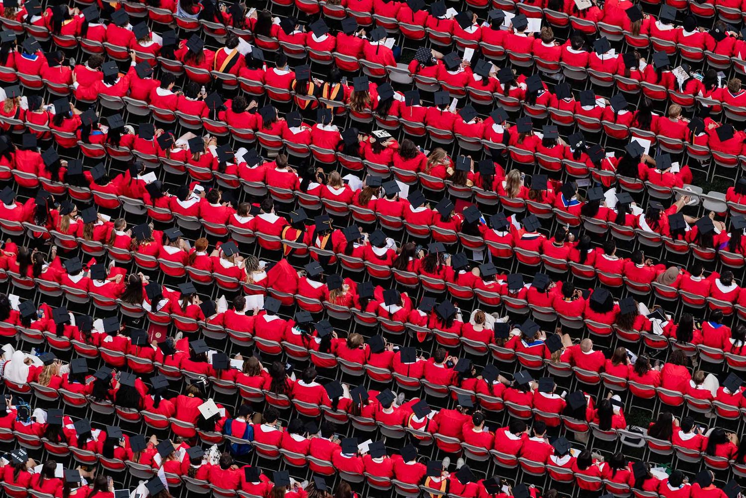 Photo: An aerial view of the crowd at Boston University's Commencement ceremony, all wearing red graduation gowns and caps