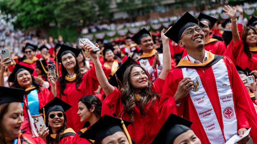 Photo: College students in red robes and caps celebrate at Boston Universitys 152nd commencement in 2025