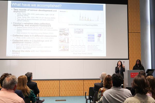Photo: Two college students giving a presentation about Climate initiatives