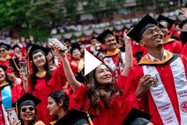 Photo: College students in red robes and caps celebrate at Boston Universitys 152nd commencement in 2025