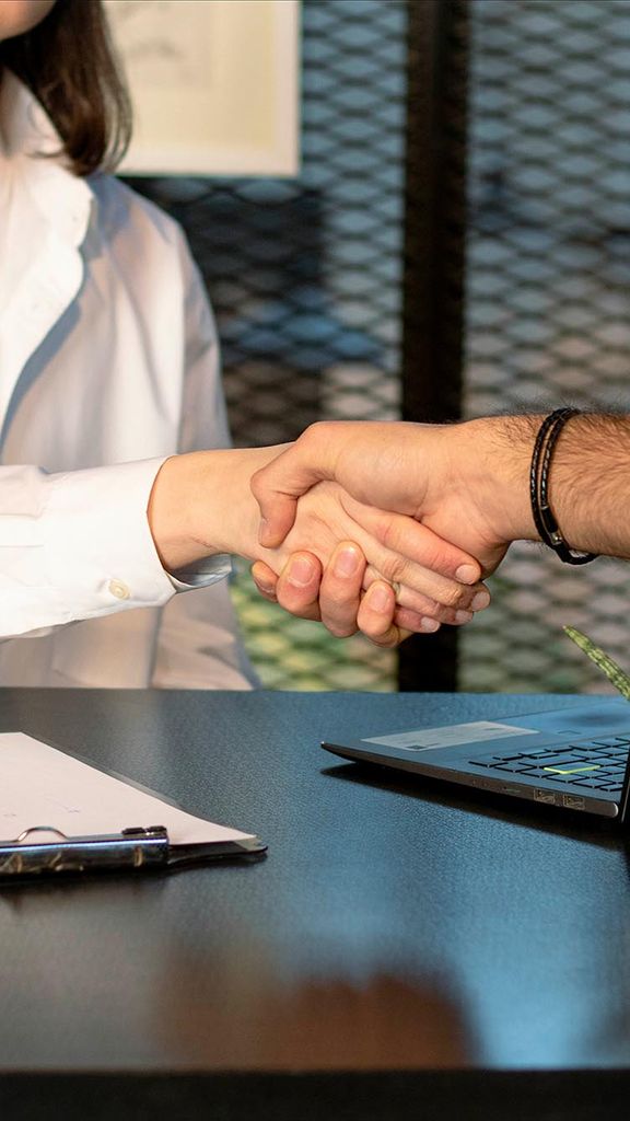 Photo: Stock image of two people shaking hands in mock interview.