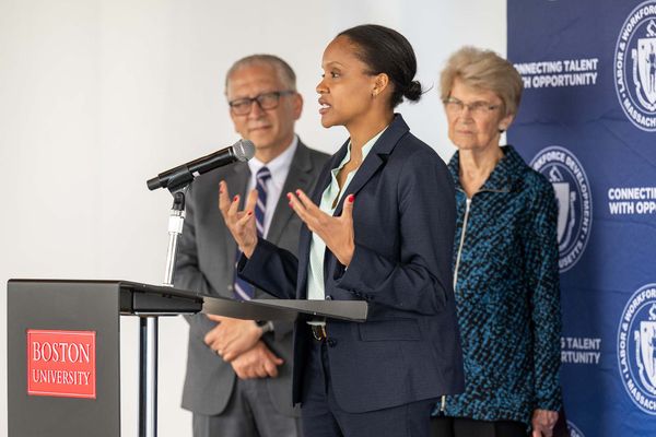 5/30/25 -- Boston, MassachusettsCDS associate provost Azer Bestavros, left, and former Lieutenant Governor of MA, and president of The WAGE Project, Inc. Evelyn Murphy, listen as Secretary of Labor and Workforce Development Lauren Jones takes the podium at a meeting to share about BU's contribution to Massachusetts' new wage-equity legislation called Pay Equity Law May 30 at CDS.Photo by Cydney Scott for Boston University Photography