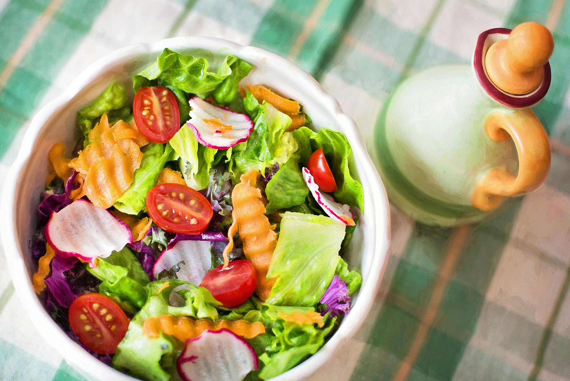 Photo: A green salad with many vegetables in a white bowl