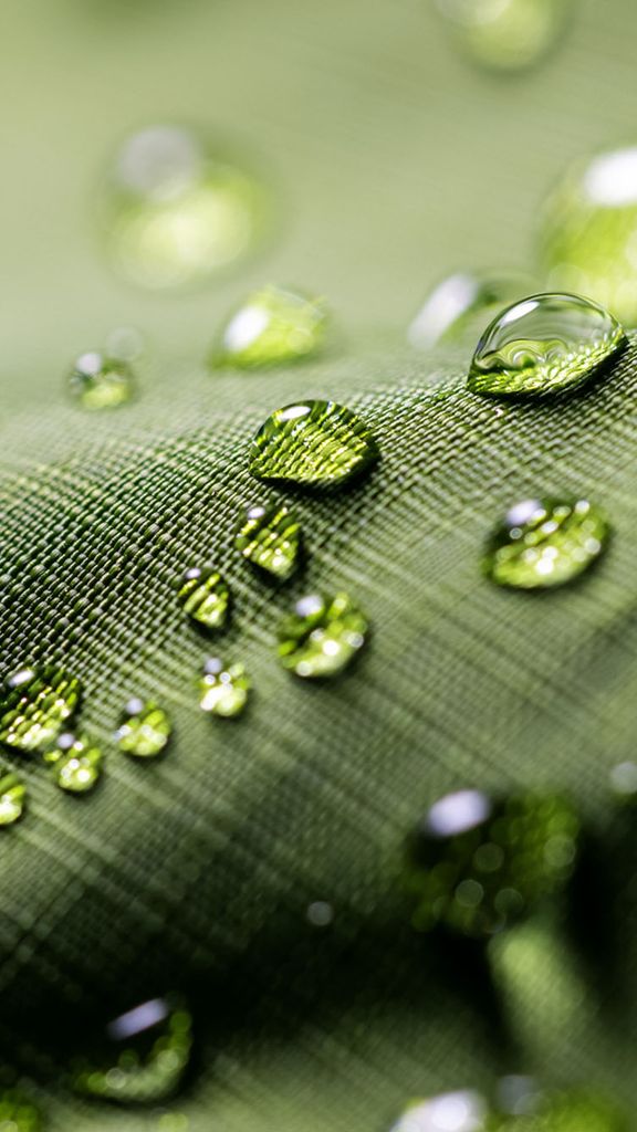 Photo: A green jacket with beads of water forming on the surface of the material