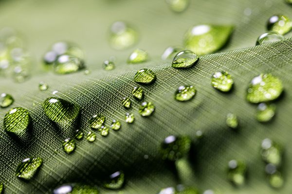 Photo: A green jacket with beads of water forming on the surface of the material