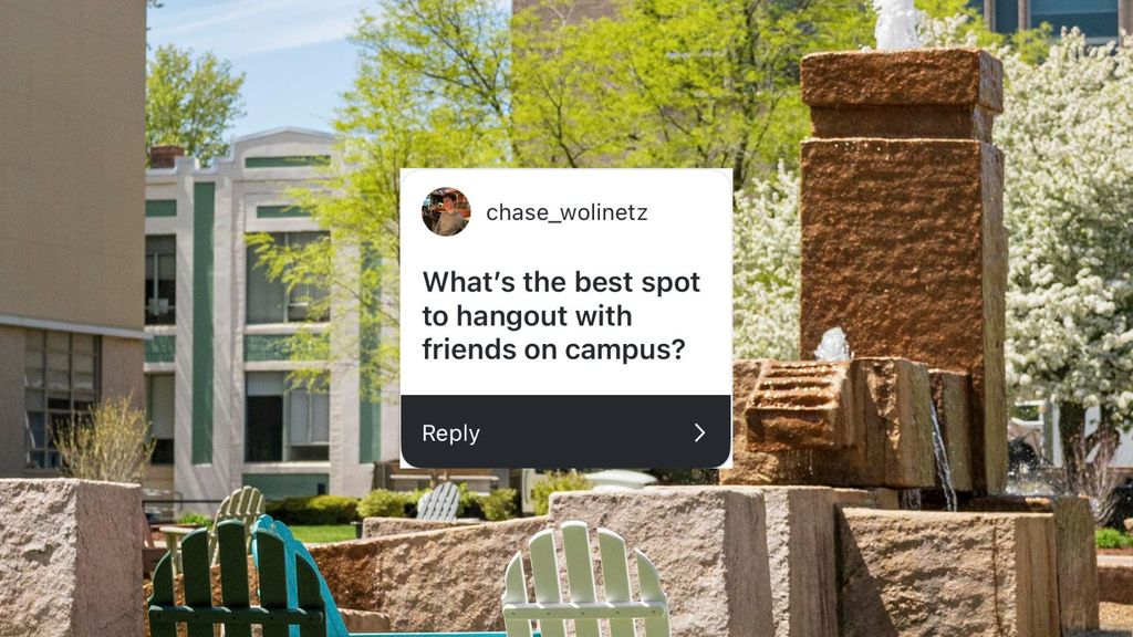A tranquil campus courtyard scene shows bright green Adirondack chairs arranged around a multi-tiered stone fountain that is actively flowing. The area is bordered by trees with spring blossoms and adjacent to academic buildings with white and green facades. The social media overlay asks: “What’s the best spot to hangout with friends on campus?” from “chase_wolinetz.”