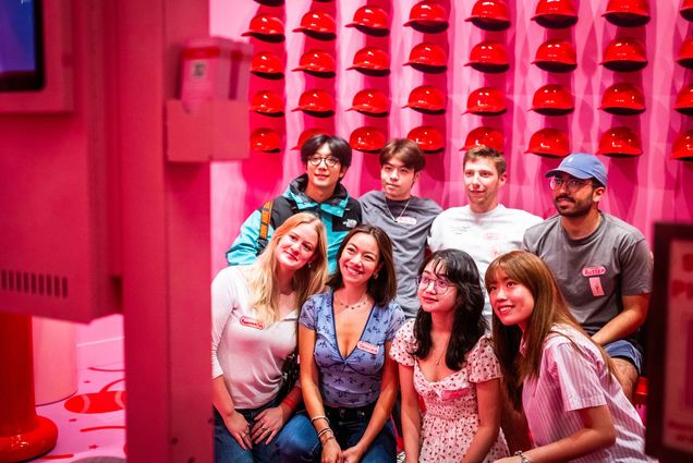 Photo: A group of people posing in front of a pink wall in Boston's Museum of Ice Cream